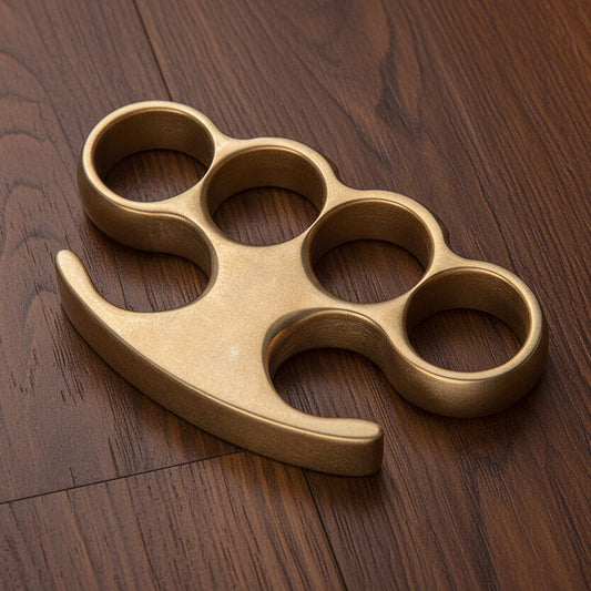 Close-up of stonewash solid brass EDC gear showing precision CNC machining and smooth edge finishing.